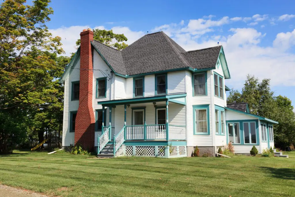 White house with blue trim and chimney.